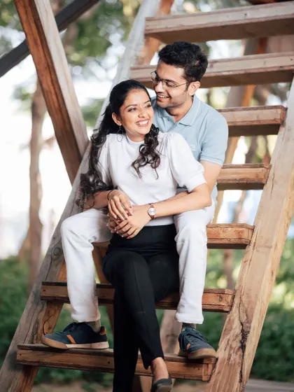 A sweet and casual moment from a styled shoot, with the couple sitting together on a wooden staircase. This shows how we can find simple, beautiful spots within a location to capture your natural connection.