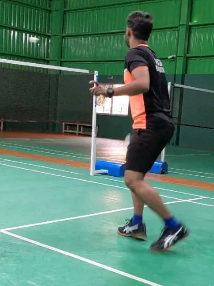 Proper footwork is crucial for covering the court effectively. This image captures the dynamic movement and body positioning involved in executing a shot from the mid-court.