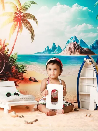 A day at the beach for her first birthday! This vibrant and fun beach theme, complete with sand, boats, and palm trees, is a unique way to celebrate turning one.