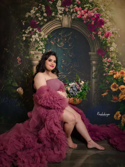 A relaxed and elegant seated portrait. The way the gown drapes around her creates a beautiful, artistic composition.