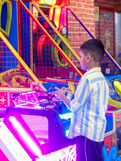 A boy takes aim at the "Skill Shooter" arcade game. It's a fun challenge for those with a competitive spirit.