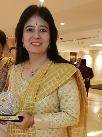A personal photo holding the 'First Ladies Award'. I dedicate this recognition to my Gurus, my family, and the timeless art of Indian classical music.