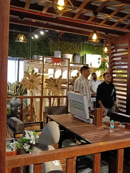 Architects on a 'Show n Tell' tour, exploring our collection of wooden furniture and decor within a custom-built pergola structure in our showroom.