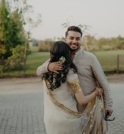 A warm embrace between the couple, their easy chemistry shining through.