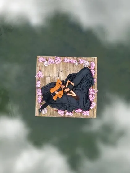 A stunning aerial drone shot of a couple on a floating raft, creating a unique and breathtaking perspective for a pre-wedding photo.