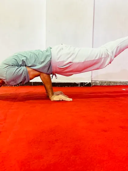 Mayurasana, or Peacock Pose, is a powerful arm balance that strengthens the entire digestive system. It requires significant wrist and core strength to hold the body parallel to the ground.