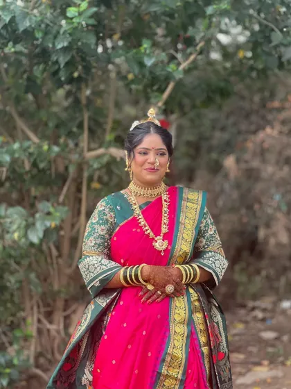 A full-length view of the bride's traditional look. The makeup is designed to complement the entire ensemble, making her look perfect from head to toe.