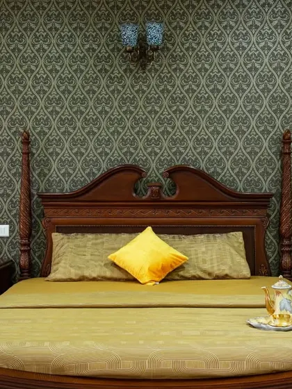 A detailed shot of the four-poster bed, showcasing the fine woodwork and the luxurious feel of the space.