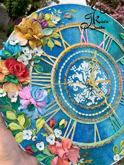 An angled view of the large galaxy clock, highlighting the depth and texture of the sculpted flowers.