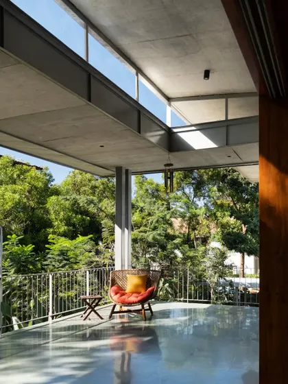The upper-level terrace in the 'House of Canopies' is a private perch overlooking the treetops. It's an open-to-sky extension of the living space, perfect for quiet contemplation.