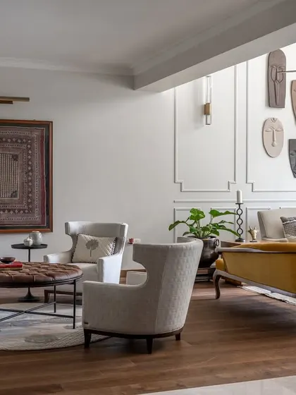 The formal and informal living spaces in the Rio Home are connected yet distinct. Here you can see the transition, with a framed textile art piece anchoring the formal seating area and drawing the eye.