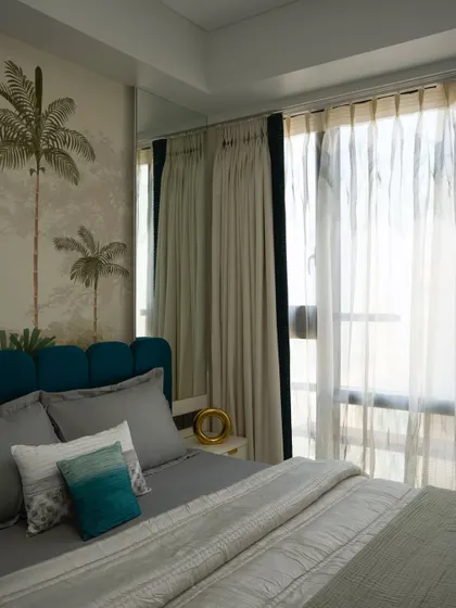 A first look at another tropical-themed guest bedroom. The bold wallpaper sets the vibe, instantly transporting you to a luxe island retreat with soft textures and earthy tones.