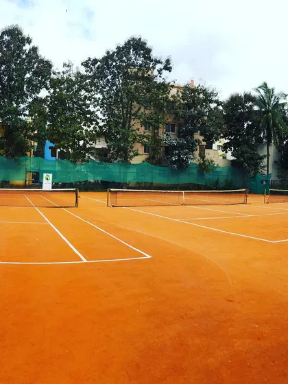 A pristine view of the empty clay courts at Tennis360 Academy, ready for the next tournament.