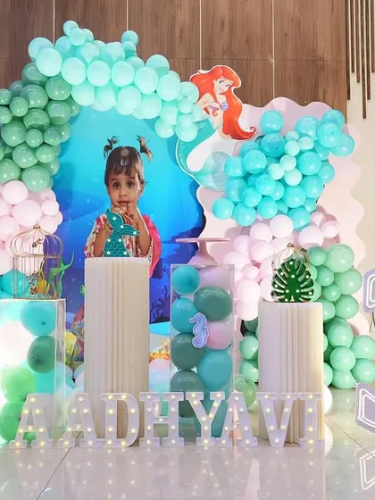 Here is a mermaid theme setup for a third birthday, with the birthday girl herself taking center stage.