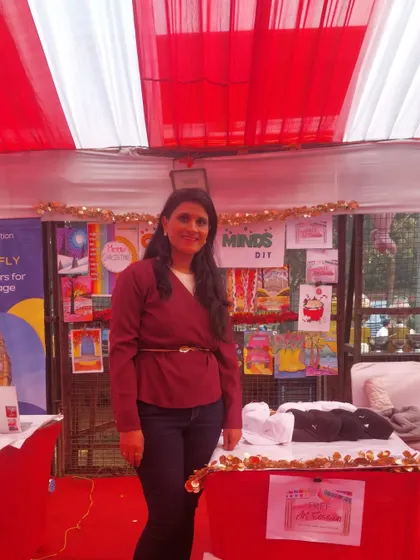 Standing proudly at my stall, surrounded by the beautiful artwork created in my classes. These events are a great way to showcase the kids' talent.