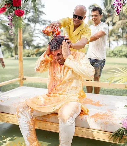 The groom's Haldi gets wild! Friends and family shower him with everything from turmeric and curd to ketchup and beer, making for hilarious and unforgettable photos.