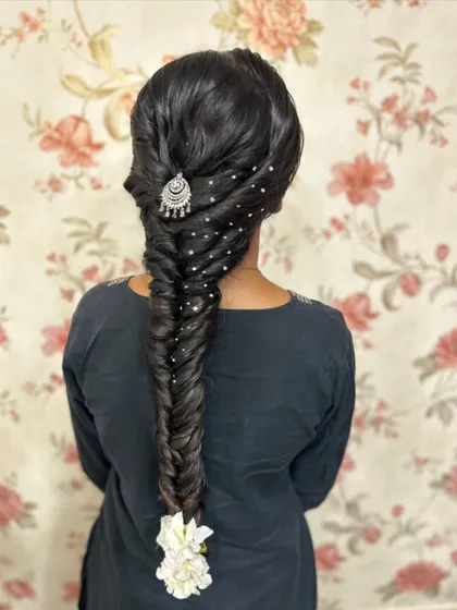 The full look of the decorated fishtail braid. This style is very versatile and can be adapted for both traditional and contemporary outfits.