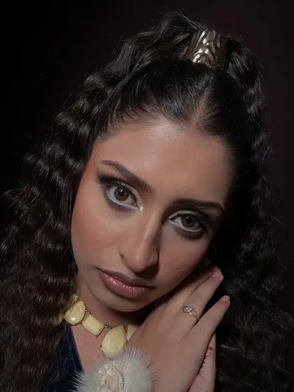 A dramatic HD makeup look designed for photography. The sharp, contrasting eyeliner in white and black makes the eyes pop, while the skin remains flawless and ready for the camera.