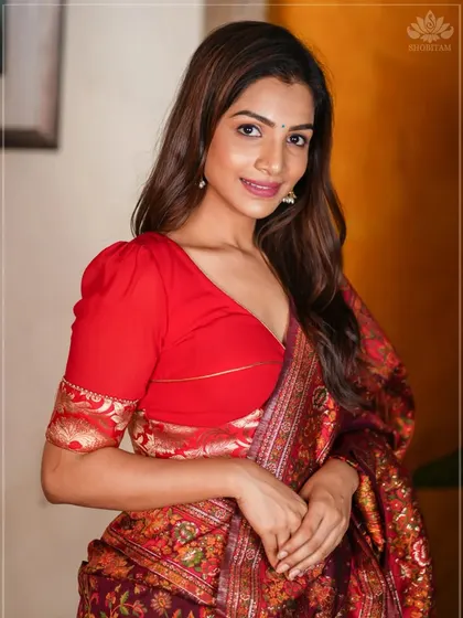 This bright red blouse with puffed sleeves and a V-neck is a classic and festive choice.