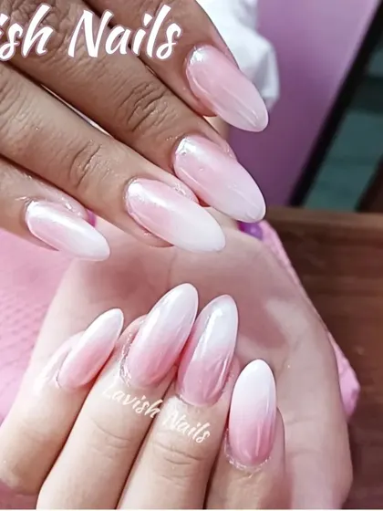 A beautiful pink-and-white ombré on long almond nails, with a glossy finish that enhances the smooth color transition.