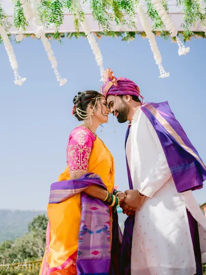 An intimate portrait of the couple against the sky, framed by the mandap decor.
