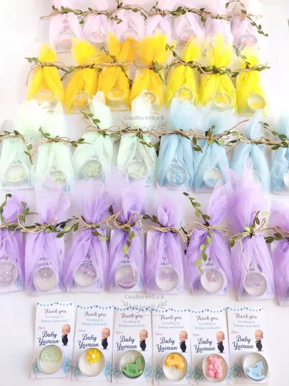 A rainbow of 80 personalized scented tealight candles, each with a unique shape and scent, made for Yuvaan's first birthday.