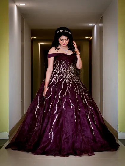 This full-length shot of the bride-to-be in a hallway uses the leading lines of the corridor to create a visually appealing and focused portrait. The lighting is set to perfectly illuminate her and her stunning gown.