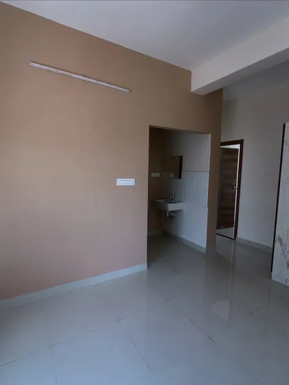 A full view of a living room project from different angles. We painted the walls in a neutral beige that pairs well with the white and wood entertainment unit, creating a warm and modern feel.