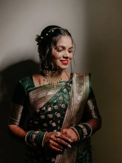 A beautiful portrait of the bride-to-be during her engagement ceremony. Her happy smile and elegant green saree make for a stunning image.