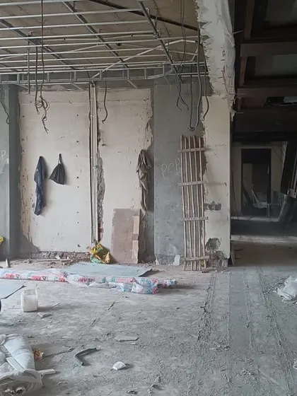 This is the "before" shot. A raw, empty construction site, filled with debris and exposed wiring, holds all the potential for the beautiful, calm, and timeless home it is about to become.