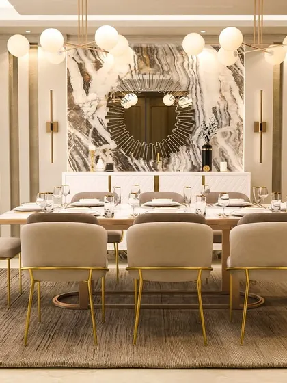This view highlights the stunning marble accent wall and sunburst mirror, creating a dramatic and luxurious focal point in the dining area.