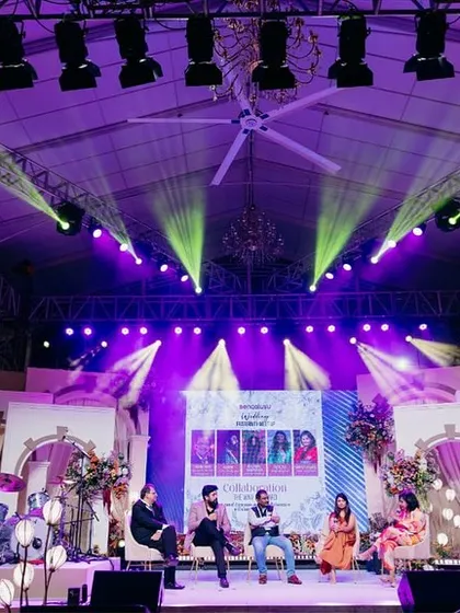 The main stage at the Bangalore Wedding Fraternity meetup, set against the backdrop we designed. The lighting and decor created a professional yet creatively charged environment for the panel discussion.
