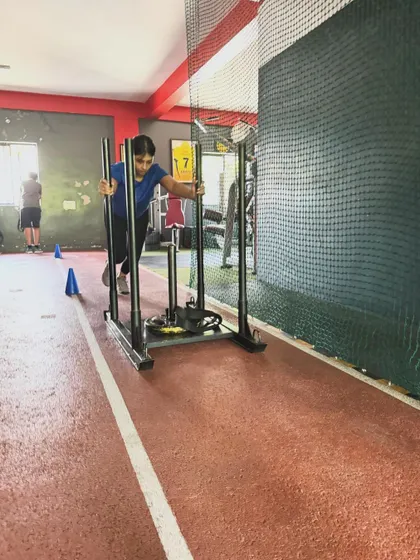 A client pushes the sled, demonstrating the commitment required to achieve fitness goals. There are no shortcuts to success.