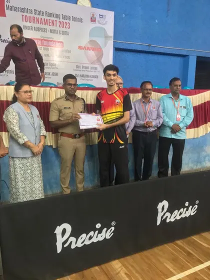 Deepit Patil receiving his certificate on the podium from officials after his Men's Singles victory at the 1st Maharashtra State Ranking tournament.