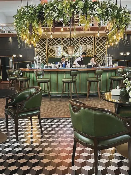The full view of the transformed bar and lounge area at the KGA. The combination of modern 3D flooring, classic leather chairs, and our custom floral decor created a high-end club feel.