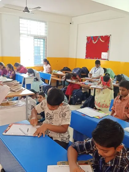 An instructor guides students during the art competition at Amara Vidya Niketan. We provide support and encouragement to help each child feel confident and inspired to do their best work.