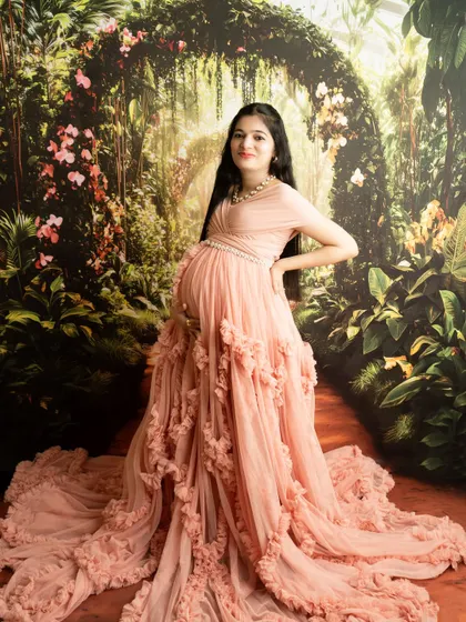 A full-length portrait showcasing a stunning ruffled gown against a garden backdrop. This pose is designed to be powerful and elegant.