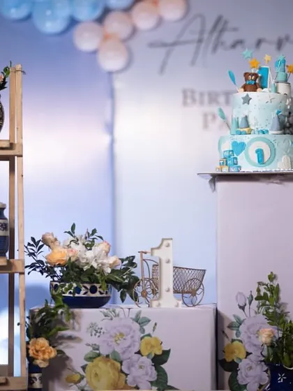 A detailed view of the props used in the blue Moroccan theme, including the cake on a pedestal and the "ONE" shelf display.