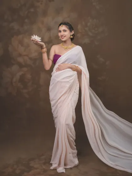 Beauty, grace, and the gentle strength of a blossoming mother captured in a single frame, wearing a delicate white saree.