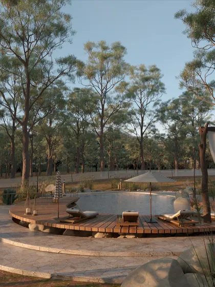 The wooden deck curves around the pool, providing ample space for sun loungers. The choice of natural wood for the decking ensures it feels warm and comfortable underfoot, further connecting the space to its natural surroundings.