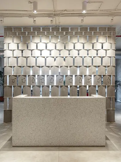 The reception at the Penguin India office immediately sets a narrative tone. A custom-designed screen made of book-like modules, some featuring the iconic dancing penguin, creates a playful yet sophisticated welcome for a company dedicated to the world of literature.