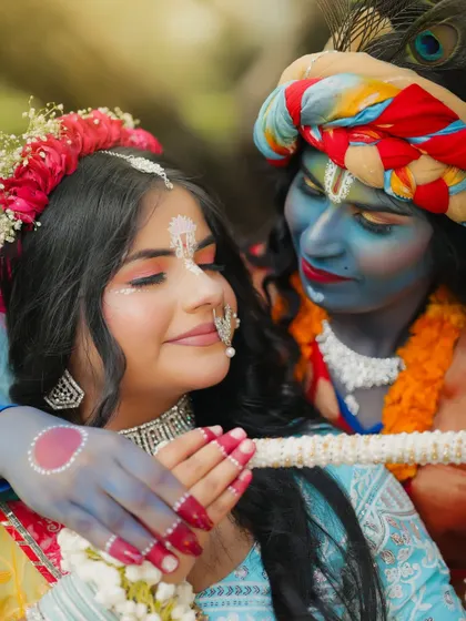 An intimate and artistic shot of Radha and Krishna, focusing on the emotion and the beautiful makeup details.