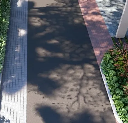 A detailed view of our street design philosophy. We challenge the norm of narrow, barren footpaths by creating shared surfaces with traffic-calming textures and ample space for large trees, making streets comfortable for pedestrians.