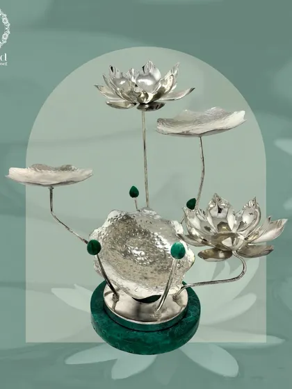 The Majesty Malachite Collection features this stunning silver-plated lotus centerpiece. With a malachite base and multiple lotus-shaped bowls, it's a piece of art that embodies regal elegance.