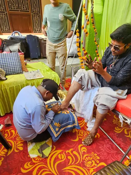 A behind the scenes look at the process. Applying foot mehndi for the groom requires patience and a steady hand to get the design just right.