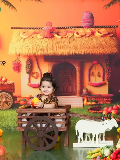 A full, bright view of the farmer theme, with a baby girl holding a piece of fruit. The colorful setup is full of charming details that bring the scene to life.