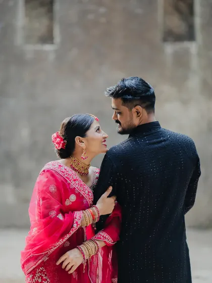 An over-the-shoulder pre-wedding shot capturing the intimate conversation and loving looks between a couple.
