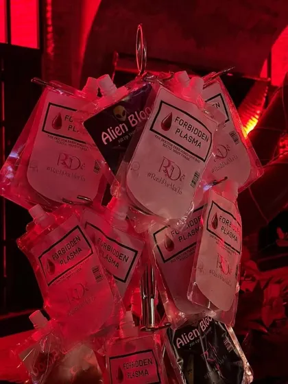 The details make the theme. At this gothic-inspired "End of Single Life" party, we served cocktails in custom-labeled "Forbidden Plasma" and "Alien Blood" IV bags, adding a playful and spooky touch that guests loved.