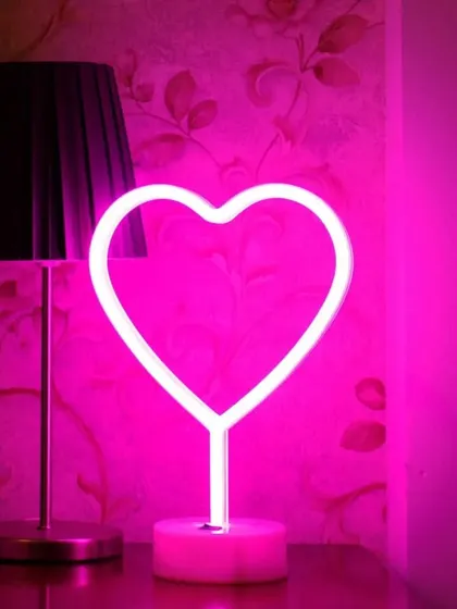A simple and sweet pink neon heart light. This can be used as part of a larger decoration or as a standalone piece to add a touch of romance to any room.