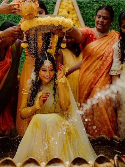 A candid moment of pure happiness during the Haldi ceremony. The traditional floral decor adds to the authenticity and beauty of the ritual.